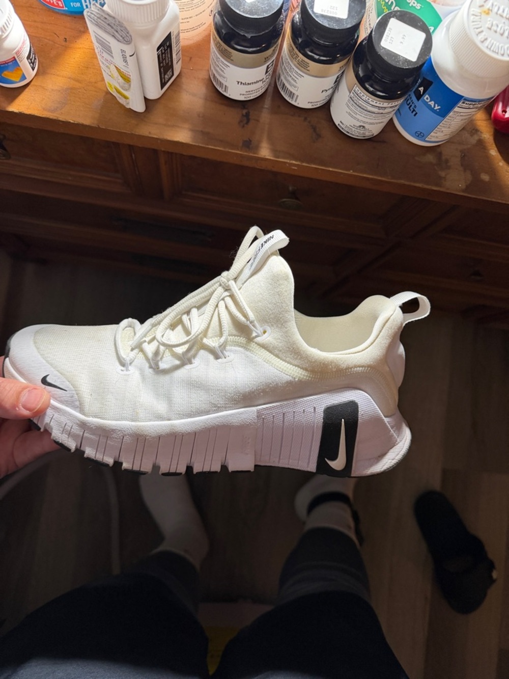 Nike cream and black slip-on athletic sneaker